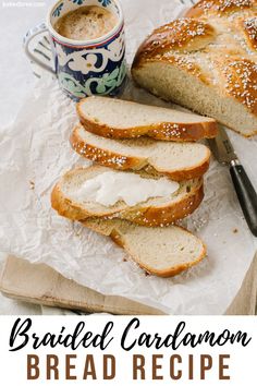 this bread is sliced and ready to be eaten with butter on top, next to a cup of coffee