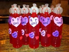 several bottles with hearts on them sitting on a table