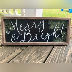 a merry and bright sign sitting on top of a wooden table