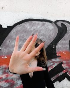 a woman making the vulcan sign with her hand