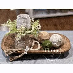 a tray with some flowers and other items on it, sitting on top of a table