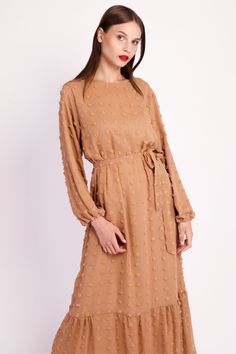 From dinner parties to special Eid holidays, the Boho Long Sleeve Pompom Maxi Dress is the perfect daily attire for every occasion. The beautiful black or brown dress features a subtle pompom design that adds a cute, trendy touch. Finished with a waist-cinching belt and a bottom tier effect, this modest lovely dress adds personality and texture to your wardrobe. Chiffon Long Sleeve Maxi Dress For Daywear, Long Sleeve Chiffon Maxi Dress For Daywear, Beige Chiffon Maxi Dress In Midi Length, Chiffon Maxi Dress For Work, Beige Maxi Dress With Tie Waist, Brown Belted Dress For Spring, Spring Brown Dress With Belt, Beige Belted Maxi Dress, Chiffon Tie Waist Maxi Dress