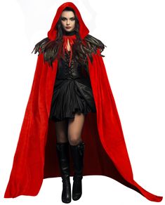 a woman in a red cape and black dress is standing with her hands on her hips