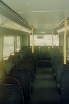 the inside of a bus with empty seats