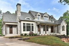 a large house in the middle of a wooded area