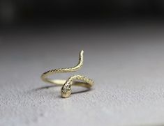 9k solid gold adjustable snake ring , made from recycled gold. Delicate and unique , The ring has been made in wax and then casted in 9k solid gold. Also available with Ruby gemstone : https://cyklu.etsy.com/listing/1575385029 MATERIAL- 9k gold Every piece you purchase from Cyklu is unique and handmade with love and affection, please allow one week after payment  ELSEWHERE - Instagram: instagram.com/CYKLU_JEWELRY -Pinterest: pinterest.com/Cyclu -Twitter: twitter.com/Cyklu - Facebook: Facebook.com/CykluJewelry Dainty Gold Ring, Ring Wrap, Dainty Gold Rings, Snake Ring, Gold Snake, Ring Dainty, Insta Instagram, Ruby Gemstone, Recycled Gold