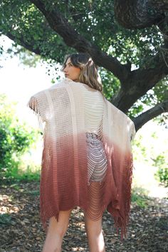 A lightweight knitted kimono with long fringe and a distressed back for an edgy, boho look. #LoveMyLeto 100% Acrylic Imported Oversized Bohemian Fall Cover-up, Bohemian Long Sleeve Fringe Cover-up, Spring Beach Cardigan With Fringe, Bohemian Knit Poncho With Fringe, One-size Fall Cardigan As Beach Cover-up, Long Bohemian Knit Cardigan, Hippie Style Fringe Poncho For Spring, Casual Fringe Cover-up For Festival, Casual Summer Fringe Cardigan