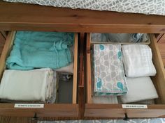 an open drawer filled with folded towels and blankets