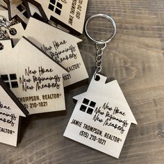 wooden house keychains with names and date engraved on them