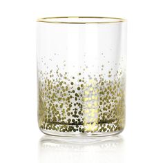 a glass filled with lots of gold dots