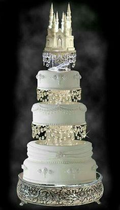 a three tiered wedding cake with white frosting and beading on the top