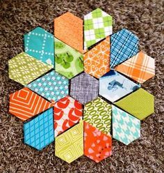 an assortment of colorful hexagons laid out on the floor in a circle