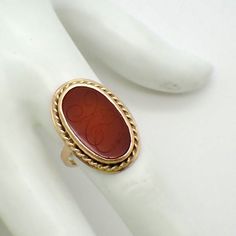 "Vintage 14 K (.585) yellow gold ring, decorated with oval form bezel-set Carnelian stone, featuring carved monogram \"XO\". This stately ring is a size 7 1/2, 1\" at the longest and weighs 8.1 grams. EA2463" Vintage Carnelian Ring, Stone Ring Design, Antique Jewelry Rings, Carnelian Ring, Gold Rings Fashion, Gold Ring Designs, Coral Ring, Rings Fashion, Carnelian Stone