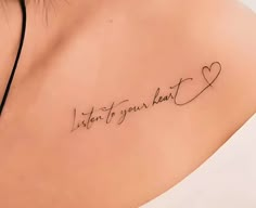 a woman's back shoulder with the words listen to your heart written on it