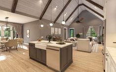 a large open concept kitchen and living room in a house with wood flooring, vaulted ceiling