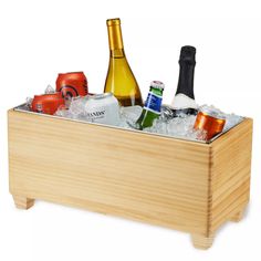 a wooden box filled with lots of bottles and ice cubes on top of a table