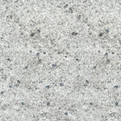 the texture of concrete is white and gray with blue dots on it's surface