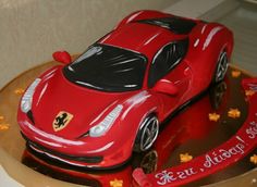 a birthday cake with a red sports car on it