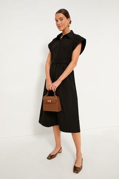 Elegant in its simplicity, the structured and ultra-ladylike Black Chloe Dress is done in a textured cotton-blend fabric that is sure to turn heads for its design details. The moire pattern throughout and trapunto stitching on the sleeves, placket, and hemline complete this midi moment, making it feel extra special with minimal effort. Pair with heels or flats, sunnies or statement earrings, for day or night, and rest assured that you look fabulous! Spread collar Short wing sleeves Button front Chic Evening Dresses With Textured Fabric, Black Structured Midi Dress, Structured Black Midi Dress, Chic Structured Dress, Modern Structured Midi Dress, Black Structured Midi Dress For Work, Black Structured Dress For Work, Structured Black Dress For Work, Black Dress With Structured Shoulders For Work