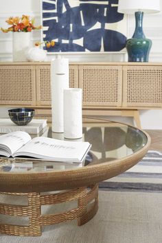 a coffee table with books and candles on it