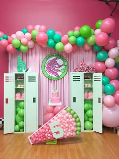 a pink and green birthday party with balloons