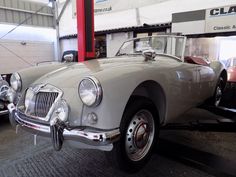 an old car is parked in a garage