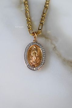 This a high quality oval Virgin Mary pendant with details on the front and back.  The shiny white stones have been mircopave set and look realistic.  The chain is a gold dipped figaro chain. We usually send 18 and 20 inch chains, but you can request another length in the note box at checkout. Original Price: $75 Virgin Mary Pendant, Mary Necklace, Virgin Mary Necklace, White Stones, Figaro Chains, Figaro Chain, Note Box, Gold Dipped, White Stone