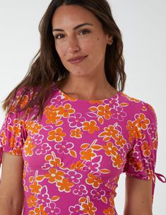 Embrace the flower power trend this Summer with this striking printed dress. Just team with your favourite sandals for a fun summer style.Made in ChinaMachine washable Round neckline Short sleeveUnfastenedModel wears a size 8Model height: 179cm / 5’10” Pink Retro Print Summer Dress, Summer Beach Retro Print Tops, Summer Beach Tops With Retro Print, Printed Pink Summer Top, Fitted Summer Tops With Retro Print, Retro Pink Top With Vibrant Print, Trendy Rose Print Tops For Summer, Spring Beach Tops With Retro Print, Summer Pink Tops With Floral Print