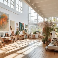 a room filled with lots of art and furniture next to large windows on the wall