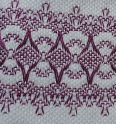 a close up of a piece of cloth that has been stitched with purple thread