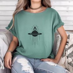 This Celestial Saturn Cross Tee is a boho-inspired shirt featuring the mount of Saturn planet design. Made with Comfort Colors fabric, this unisex Garment-Dyed Tee provides a relaxed fit and a crew neckline, making it perfect for casual and semi-formal settings. Ideal for those who love celestial designs, this tee is great for everyday wear and can be accessorized for a unique touch. Perfect for astrology enthusiasts and those who appreciate ethically sourced US cotton fabric. Great for holidays, celebrations, and occasions that celebrate the cosmos. Product features - Available in multiple sizes from S to 4XL - Double-needle stitching for durability - Garment-dyed fabric for soft color and texture - Ethically sourced US cotton - Relaxed fit and crew neckline for comfort and style Care ins Bohemian Soft-washed Tops With Crew Neck, Bohemian Style Soft-washed Crew Neck Tops, Bohemian Soft-washed Crew Neck Top, Free-spirited Cotton Crew Neck Top, Hippie Soft-washed Relaxed Fit Tops, Hippie Style Soft-washed Relaxed Fit Top, Bohemian Soft-washed Relaxed Fit Top, Bohemian Soft-washed Relaxed Top, Bohemian Cotton T-shirt With Graphic Print