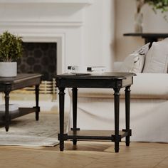 a living room scene with focus on the end table and coffee table in the foreground