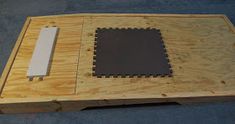 a piece of wood that has been made into a puzzle board with black and white squares on it