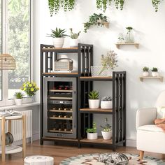 a living room filled with lots of plants next to a white chair and wall mounted shelves