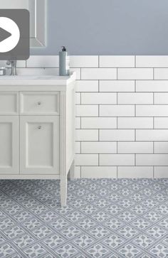 a bathroom with blue and white tile on the floor