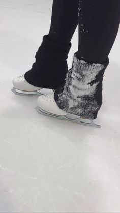 someone is standing on the ice with their feet covered in snow