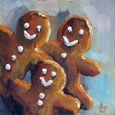 three gingerbreads with white frosting on them sitting in front of each other