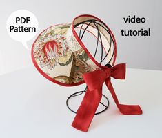 a red ribbon tied around a decorative object with the words pattern and video instructions below it