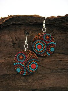 the earrings are decorated with colorful circles