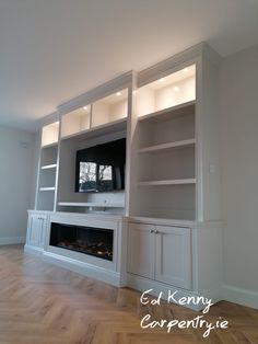 an empty living room with built in entertainment center