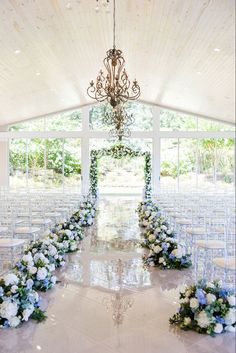 an indoor wedding venue with white and blue flowers