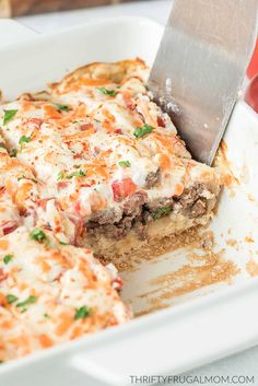 a close up of a slice of pizza in a pan with a spatula on the side