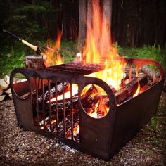 an outdoor fire pit with flames and logs