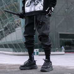 Tactical performance meets streetwear style: discover our surprising Functional Pants. Imagine navigating the city's bustling streets, each step revealing a sense of purpose and unwavering determination. You embody modern urbanity, thriving in the pulse of the metropolis. The cornerstone of your powerful allure? The Functional Pants. These techwear pants are the epitome of cutting-edge fashion, engineered for the young dynamic urban dwellers seeking elegance and functionality. Meticulously desig Street Techwear, Dark Tiger, Costume Pants, Avant Garde Aesthetic, Apocalyptic Clothing, Gothic Pants, Techwear Pants, Tactical Cargo Pants, Streetwear Pants