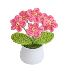 small crocheted pink flowers in a white vase