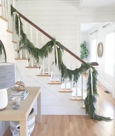 a christmas garland is hanging on the banister