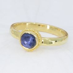 This beautiful 18K Treasure Gold ring, crafted with sunken treasure, showcases a majestic 0.83ct rose-cut blue sapphire. Enjoy the delightful shimmer of its water-ripple band, while its ancient feel adds a touch of mystery to any outfit. While I can make similar style rings, this one is one-of-a-kind owing to the irregular cut of the gem. Handcrafted in solid 18K gold made with 400 year-old sunken treasure recovered from the Caribbean. Size 7.25, but each ring comes with free sizing and FREE SHI Handmade Yellow Gold Sapphire Ring, Gold Hand Forged Sapphire Ring, Hand Forged Gold Sapphire Ring, Hand Forged Blue Sapphire Ring Gift, Hand Forged Blue Sapphire Ring For Anniversary, Anniversary Blue Hand Forged Sapphire Ring, Treasure Gold, Sunken Treasure, Blue Sapphire Ring