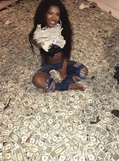 a woman sitting on top of a bed covered in money