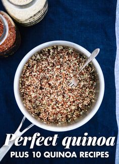 a white bowl filled with granola next to two spoons on top of a blue towel