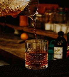 a glass filled with liquid sitting on top of a table